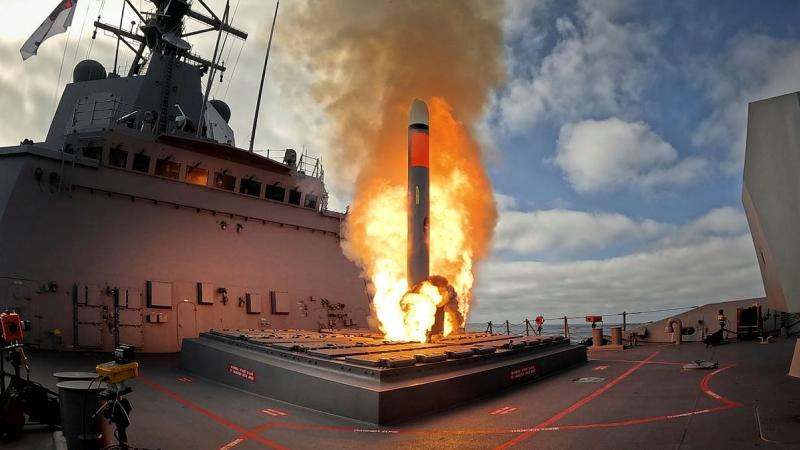 A missile launches from a ship.