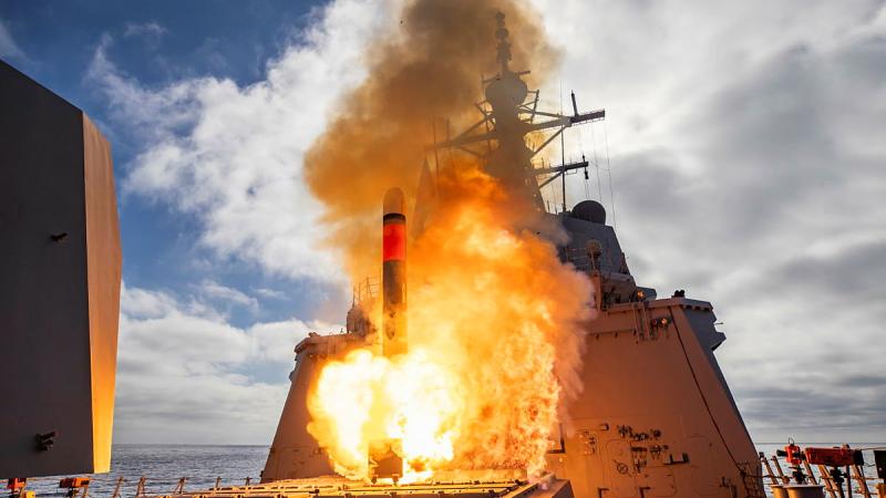 A missile launches from a ship.