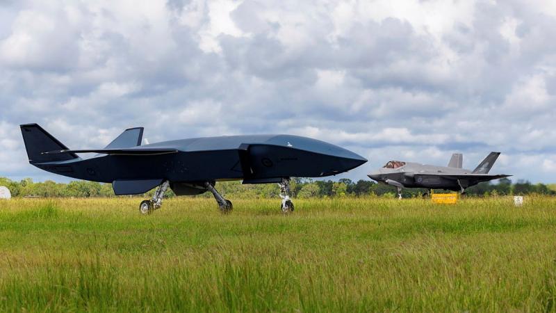 A black aircraft on the runway.