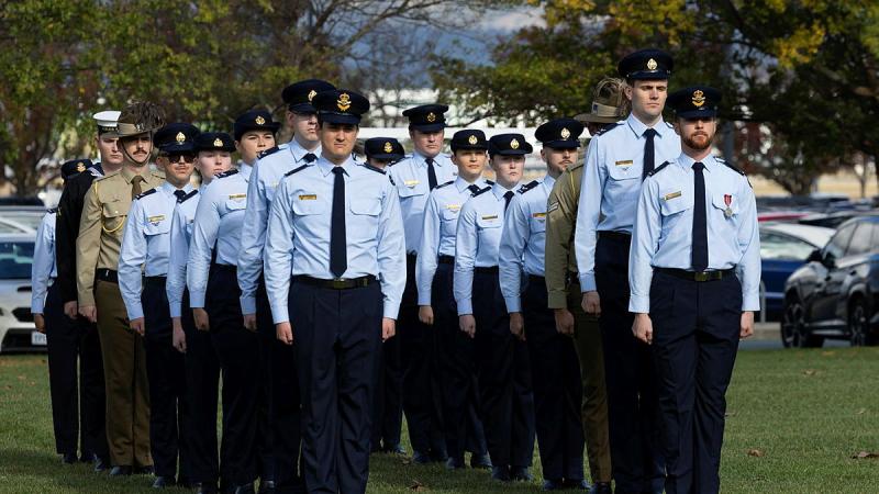 A group of people in Air Force uniform stand to attention.