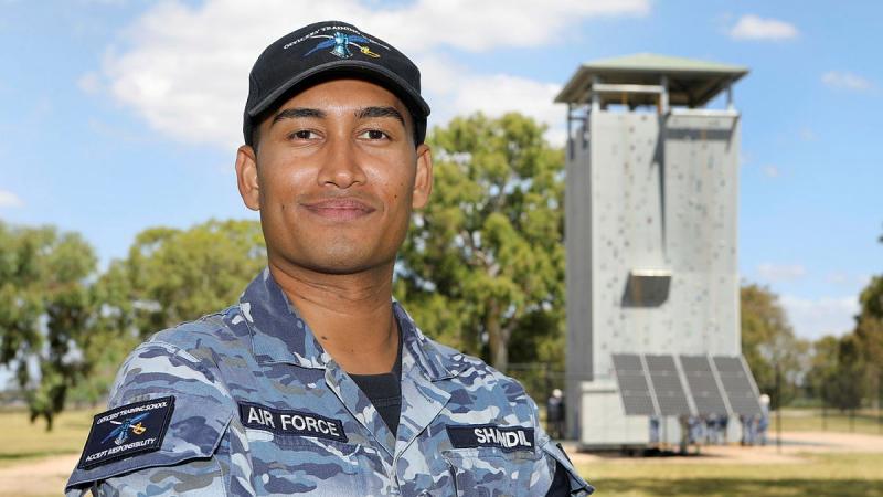 A man in Air Force uniform standing with his arms crossed posing for the camera.