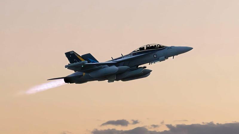 An aircraft in flight at sunset.