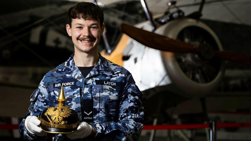 Air Force Imagery Specialist Leading Aircraftman Campbell Latch, holds a First World War German spiked helmet at the RAAF Base Amberley History and Heritage Centre, Queensland. 