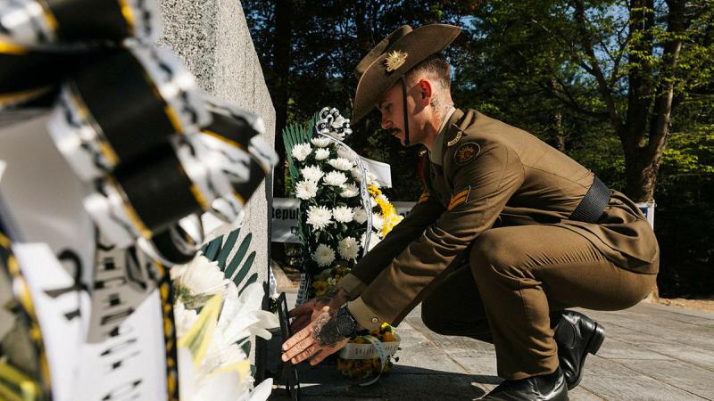 A soldier places a wreath.