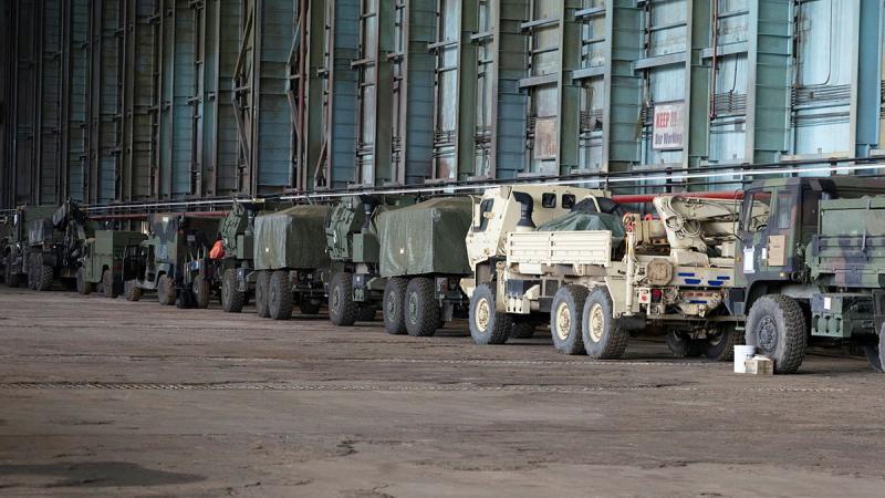 Vehicles, including US HIMARS, lined up ready to be loaded onto a vessel during Exercise Balikatan 26.