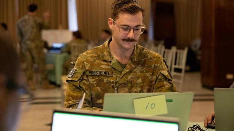 A soldier at a computer.
