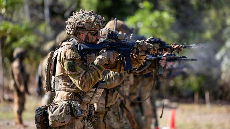 Soldiers fire weapons.