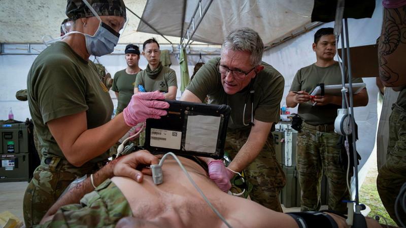 A medical team work on a patient.