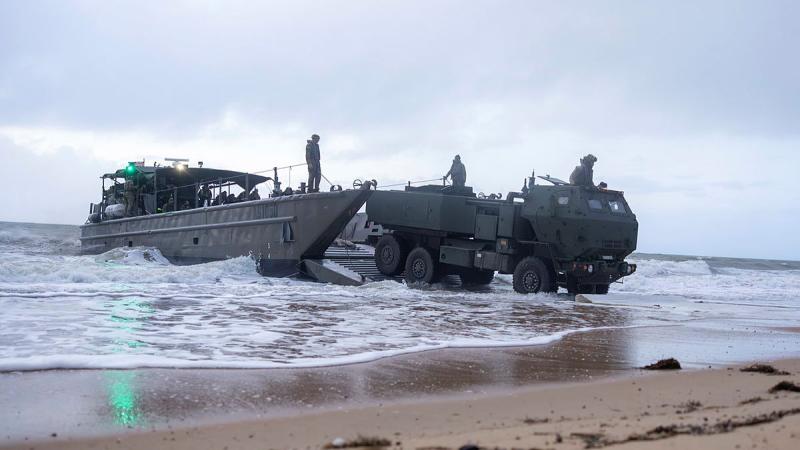 The High Mobility Artillery Rocket System (HIMARS) coming ashore from a LMC- 8 during Exercise Black Cutlass at Cowley Beach Queensland.