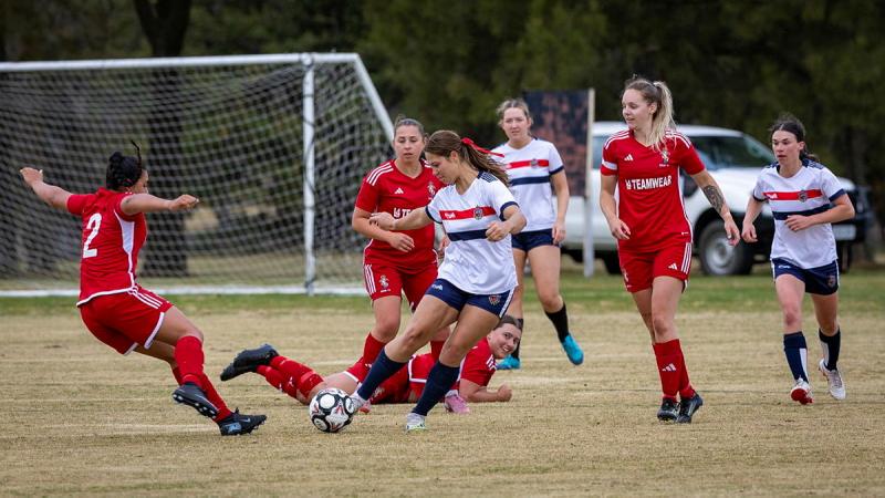 Australian Army Officer Cadet Johanna Whittle kicking the ball during a game against the British Royal Electrical and Mechanical Engineers football team in Canberra 2026.