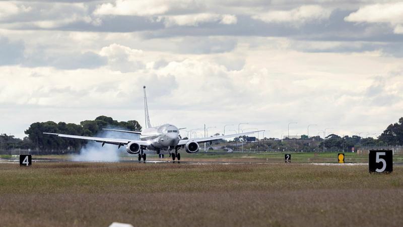 An aircraft taxis on the runway. 