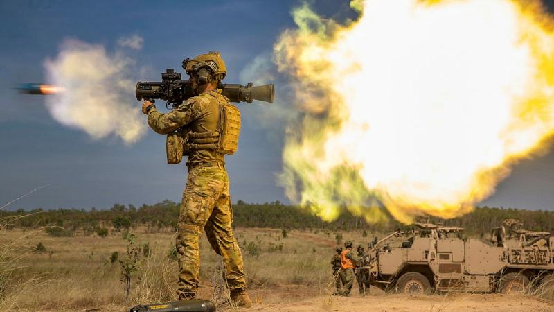 A military member fires a weapon.