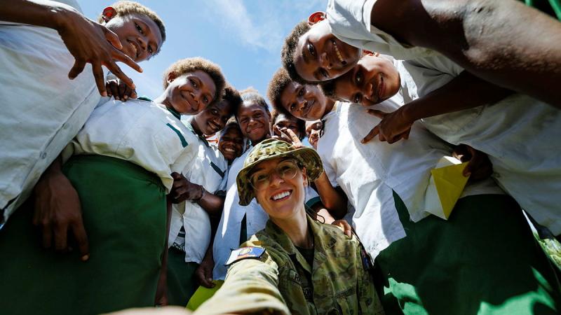Capt Annie Richardson takes a selfie with children at Takabur Primary School in Kokopo, PNG during Operation Render Safe. Photo: Sgt Andrew Sleeman