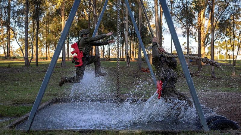 Australian Army trainees from the School of Infantry take a leap of faith over a water obstacle during Exercise HardCorps to complete their Riflemen's course at Singleton Military Area, NSW.