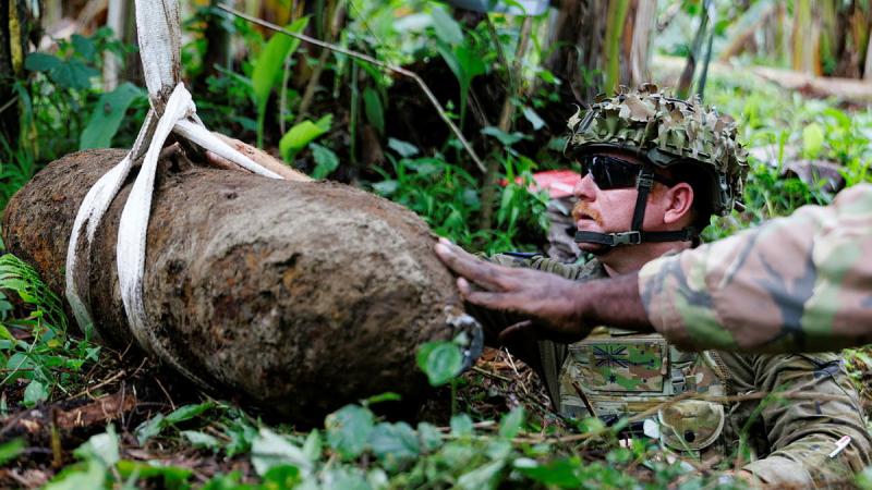 Explosive Ordnance Technician, Australian Army Sergeant Philip Rutherford removes a 250lb bomb from a community in East New Britain, Papua New Guinea during Operation Render Safe.