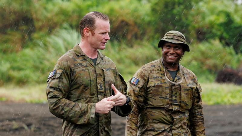 Australian Army Warrant Officer Mitchell Dolan (L) and Captain Adam Ampa'oi (R) deliver orders in East New Britain, Papua New Guinea on Operation Render Safe 26.