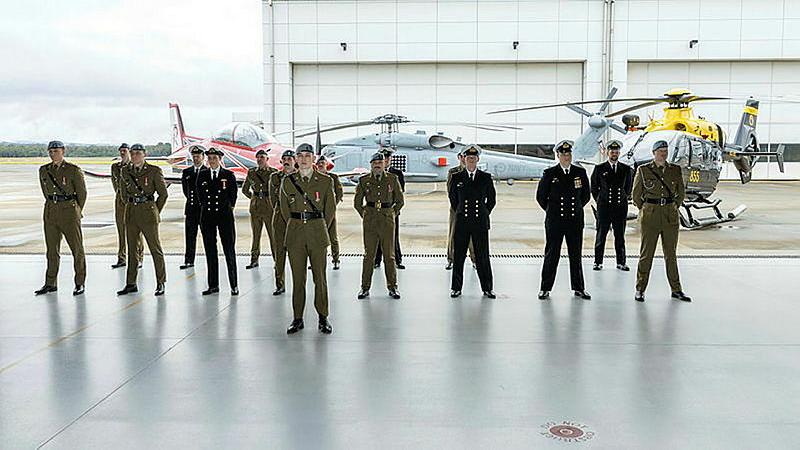Army and Navy aviation professionals on parade in a hangar after the Joint Helicopter School graduation at HMAS Albatross.