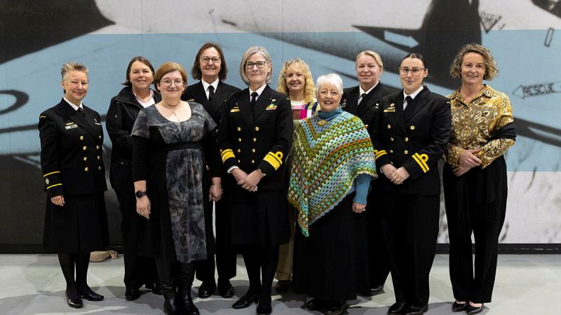 A group of women standing together posing for the camera.