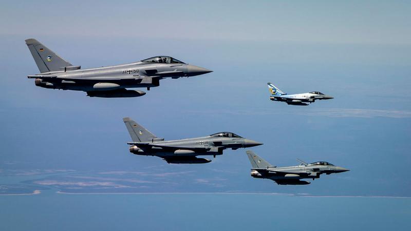 Four aircraft fly in formation.