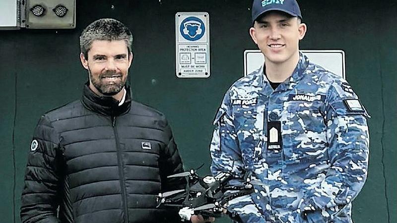 Defence contractor Simon Doering and OFFCDT Declan Jonauskis with the drone used during the EDGY autonomous ISR project.