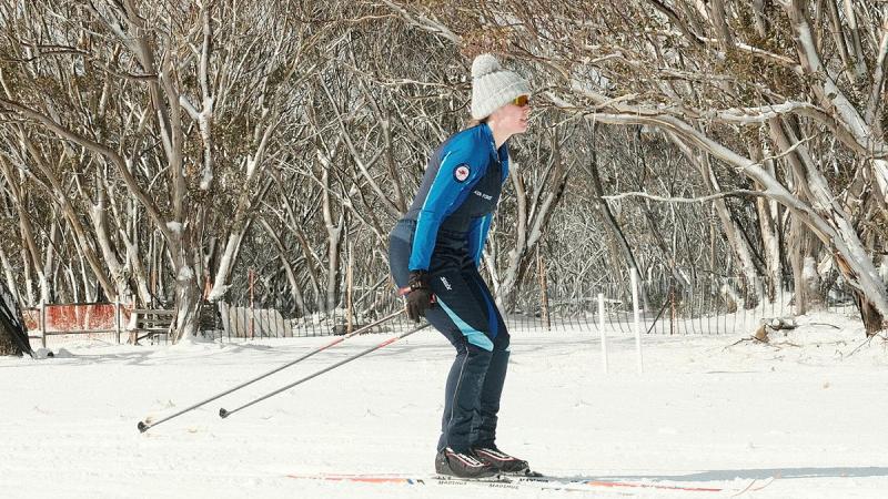 An Air Force woman skis on a flat run.