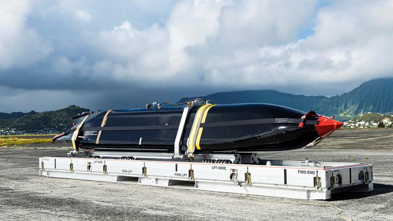 A missile is strapped down on the tarmac.
