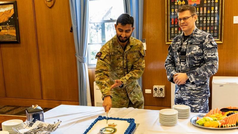 Personnel cut a cake to celebrate 89 years of Richmond Officers' Mess. 