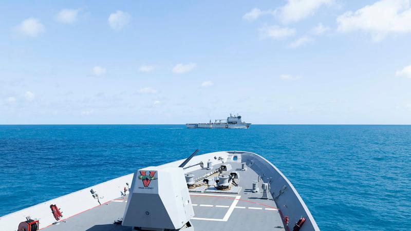 The bow of one ship points towards another ship in the distance.