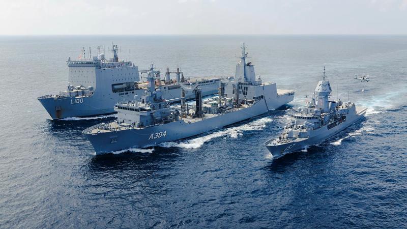 Three ships sailing next to each other.