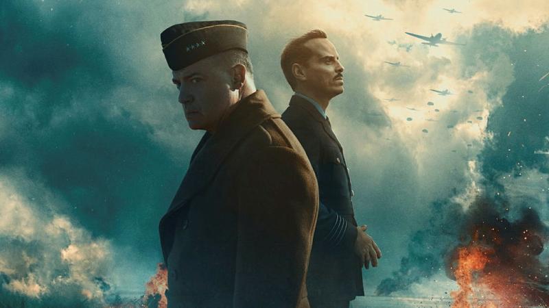 Two military men standing against a backdrop of dark storm clouds and planes in the distance.