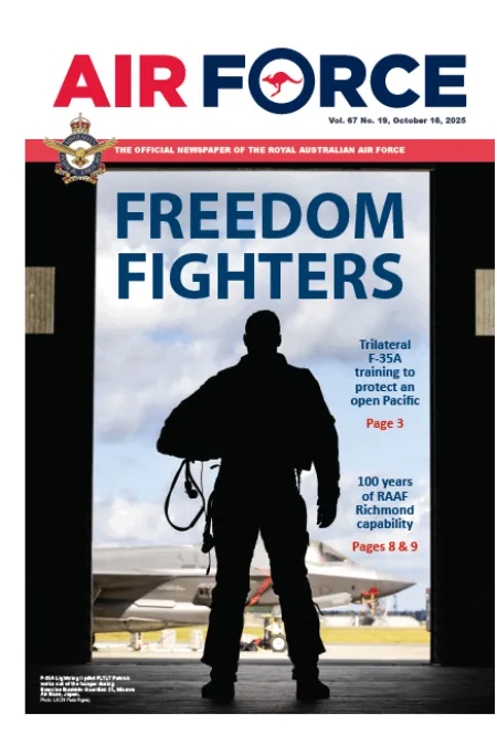 Cover of Air Force newspaper showing the silhouette of an aviator standing in a hangar doorway, with the headline “FREEDOM FIGHTERS.” Story highlights trilateral F-35A training in the Pacific.