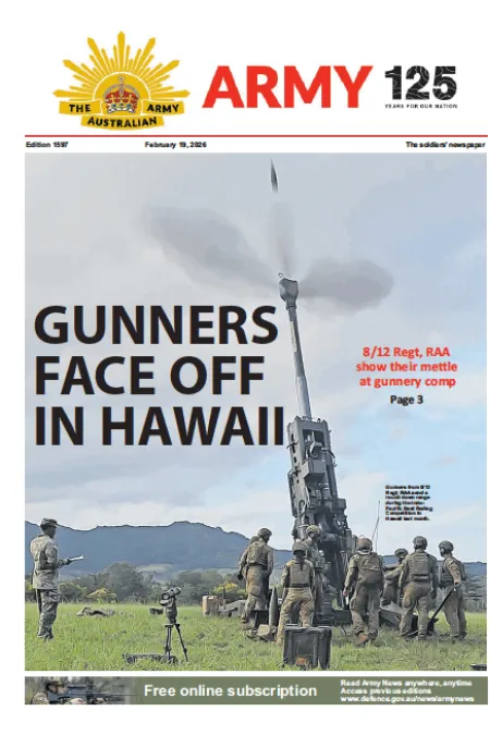 Artillery personnel operate a howitzer during a live-fire exercise in Hawaii, with a round visible in the sky above.