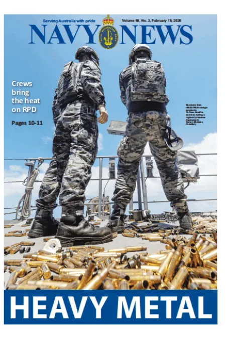 Front cover of Navy News showing two naval personnel standing on a ship’s deck with spent shell casings scattered in the foreground, with the headline “HEAVY METAL.”