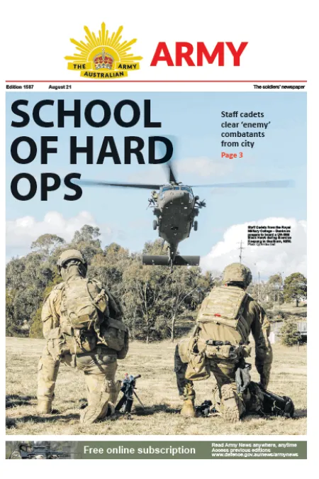 Front cover of Army newspaper featuring two soldiers kneeling in a field as a military helicopter hovers overhead, with the headline “SCHOOL OF HARD OPS.”
