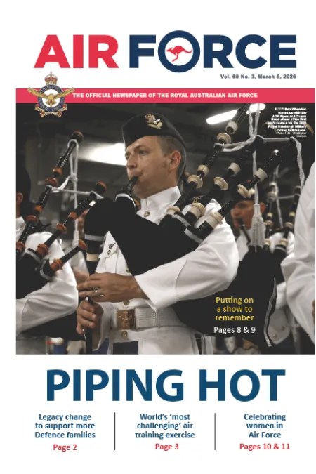 Air Force newspaper cover showing a military bagpiper in ceremonial uniform playing bagpipes, with the headline “PIPING HOT.”
