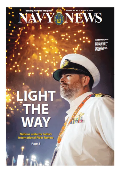 Front cover of Navy News featuring a naval officer in white ceremonial uniform standing before fireworks, with the headline “LIGHT THE WAY.”