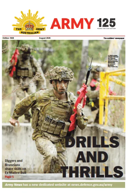 Army newspaper cover showing a soldier carrying a red training rifle while running through a military obstacle course, with other personnel and training structures in the background. Headline: “DRILLS AND THRILLS.”