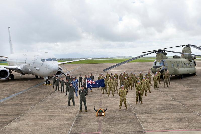 Australian Defence Force personnel from No 12 Squadron and 5th Aviation Regiment stand for a group photo during the historical callsign handover ceremony at RAAF Base Townsville, QLD.