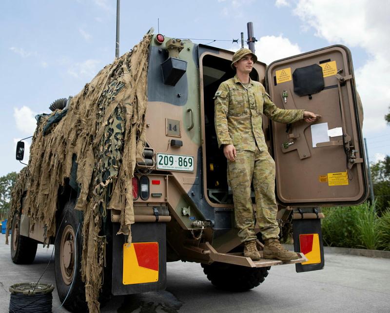 Corporal Max Helion, of 7th Combat Signal Regiment, prepares the communication systems on a Bushmaster Protected Mobility Vehicle during Exercise Mercury Run.