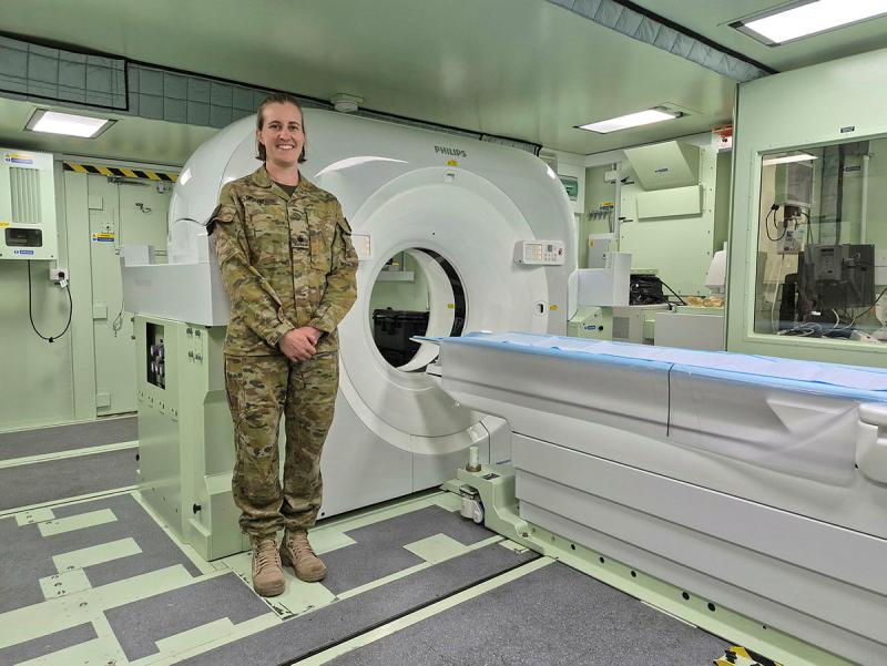Major Gabrielle Grant, Army Senior Radiographer, stands in front of the deployable CT scanner being used on Exercise Viper Walk in Enoggera Close Training Area. This is the first time a deployable CT scanner has been used by the Australian Defence Force in field conditions, representing a major step forward in capability and training quality.