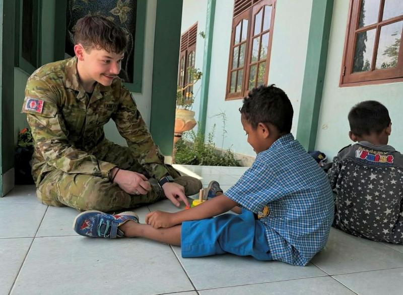 Air Force Imagery Specialist Leading Aircraftman Campbell Latch, speaks with a child from an orphanage in Dili whilst deployed on Exercise Indo-Pacific Endeavour, Timor-Leste.