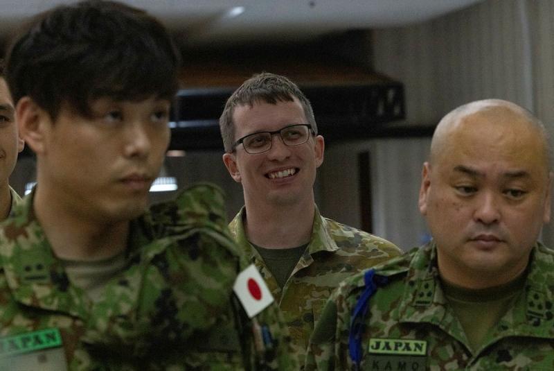 Three men in military uniform standing together.