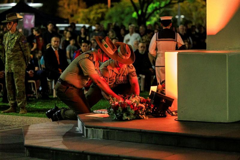 Personnel lay a wreath.