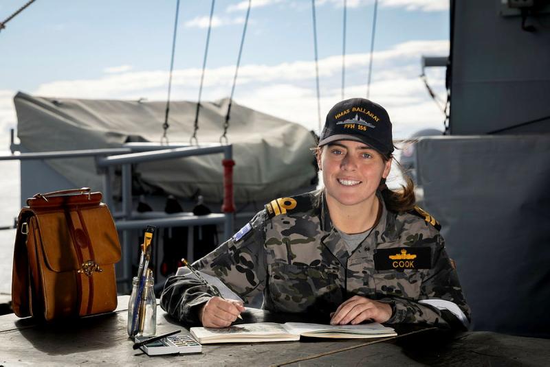 Principal Warfare Officer, Lieutenant Emma Cook uses her watercolour paints on the upper deck of HMAS Ballarat while at sea.