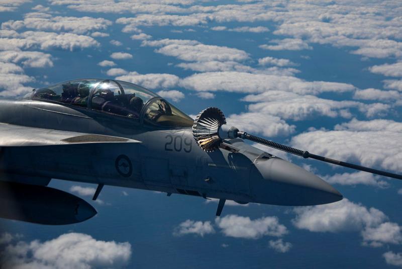 An aircraft with a device attached mid-flight.