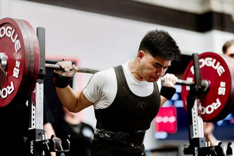 A man prepares to lift a weighted bar.