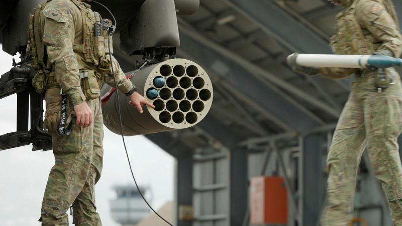 Australian Army Aviation Ground Crew load 70 millimetre rockets on an AH-64E Apache during Exercise Possum Walk, RAAF Base Townsville, QLD.
