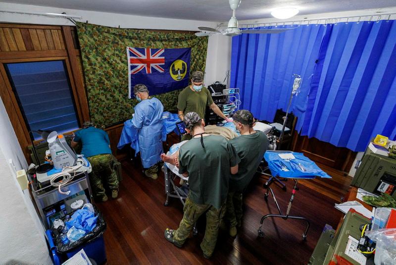 Australian Army Medical staff perform minor surgery on a member of Operation Render Safe 26, at the Role 2 in Kokopo, Papua New Guinea.