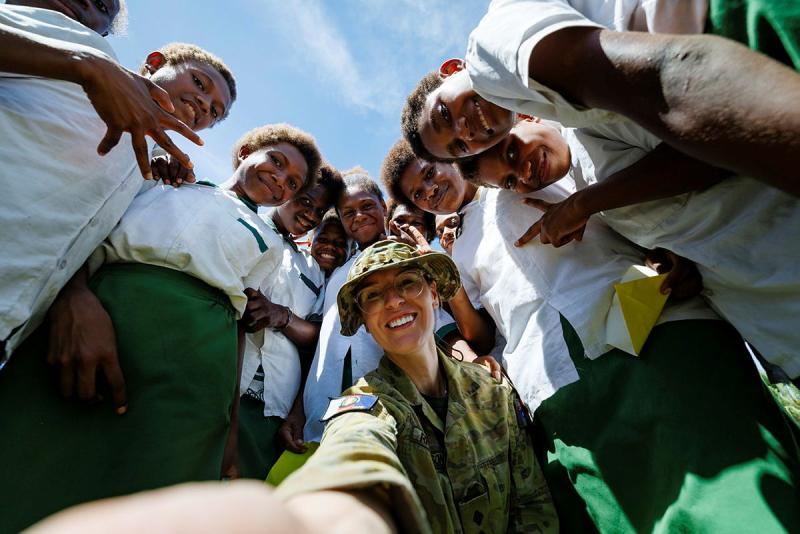 Capt Annie Richardson takes a selfie with children at Takabur Primary School in Kokopo, PNG during Operation Render Safe. Photo: Sgt Andrew Sleeman