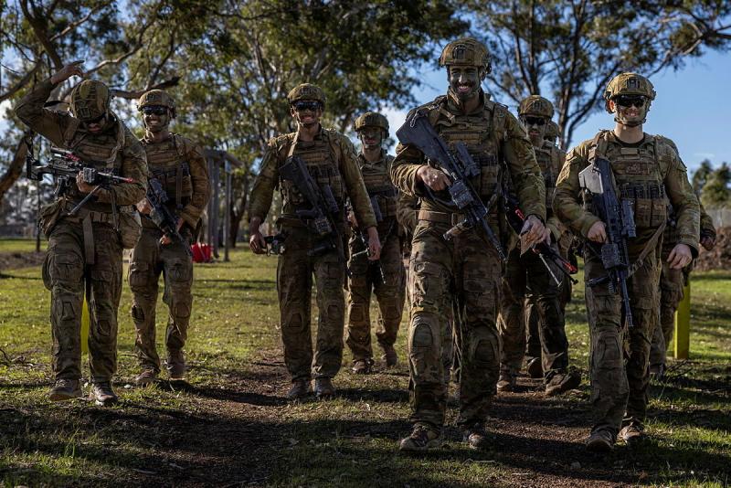 Australian Army trainees from the School of Infantry smile after completing the final live-fire assessment during Exercise HardCorps to complete their Riflemen's course at Singleton Military Area, NSW.